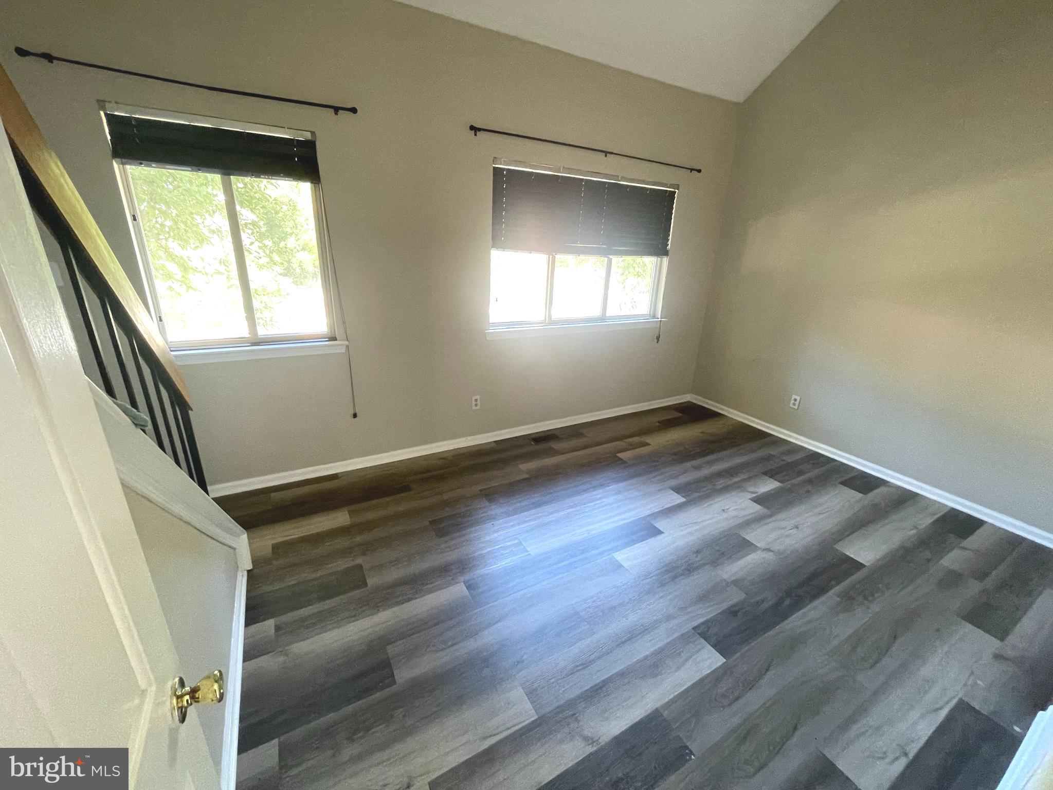 214 Carriage Court, Unit 214 Chesterbrook, PA 19087 - Photo 24 of 41 a view of an empty room with wooden floor and a window