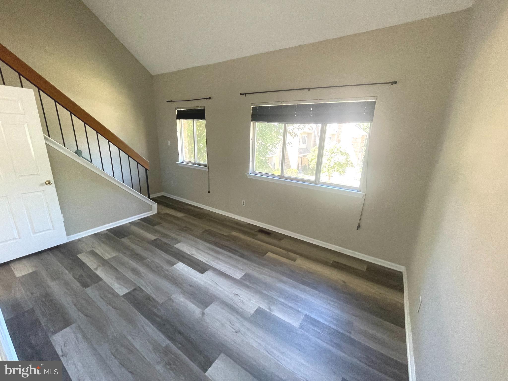 214 Carriage Court, Unit 214 Chesterbrook, PA 19087 - Photo 26 of 41 a view of an empty room with wooden floor and a window