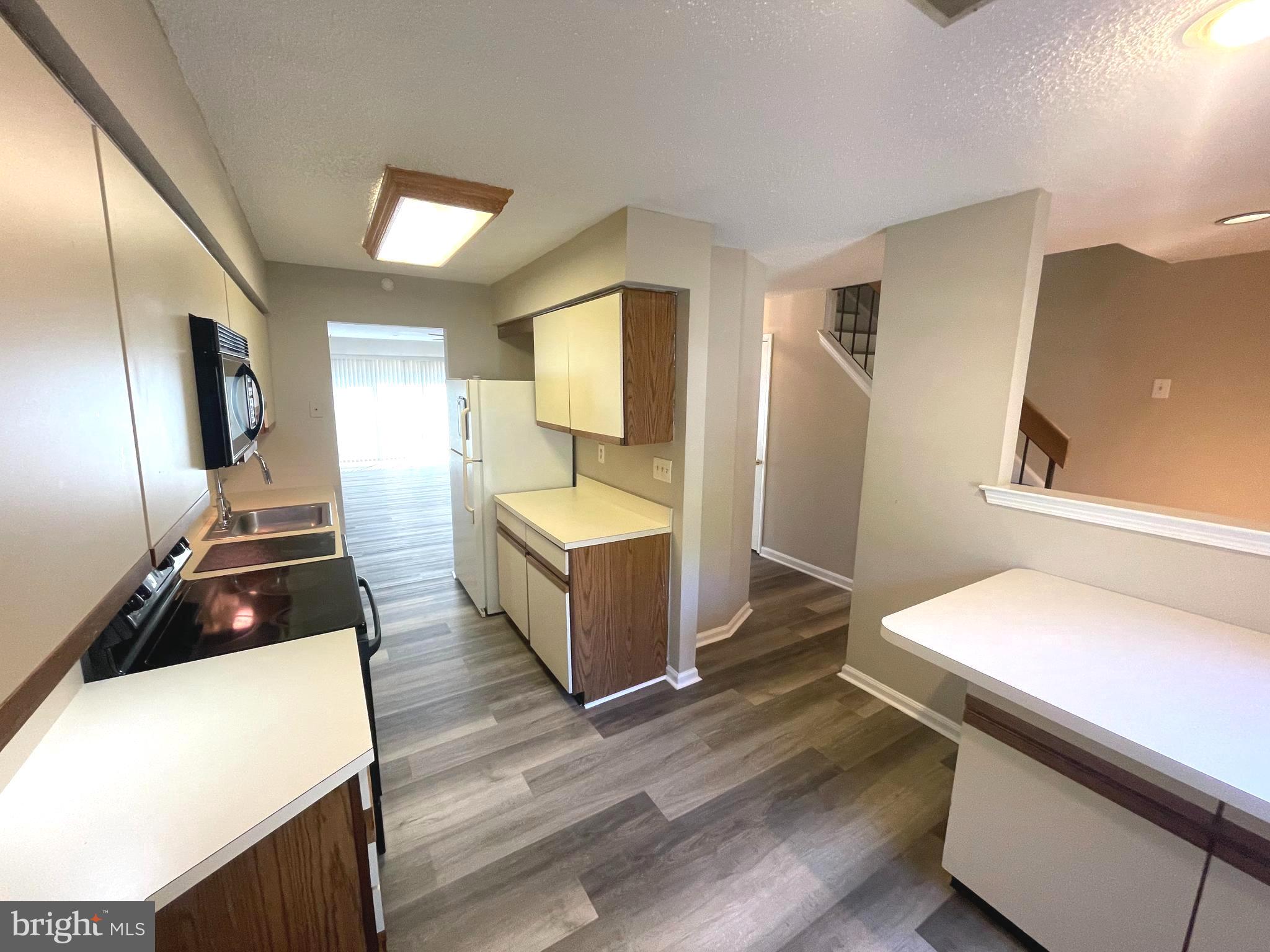 214 Carriage Court, Unit 214 Chesterbrook, PA 19087 - Photo 6 of 41 a kitchen with a sink and wooden floor