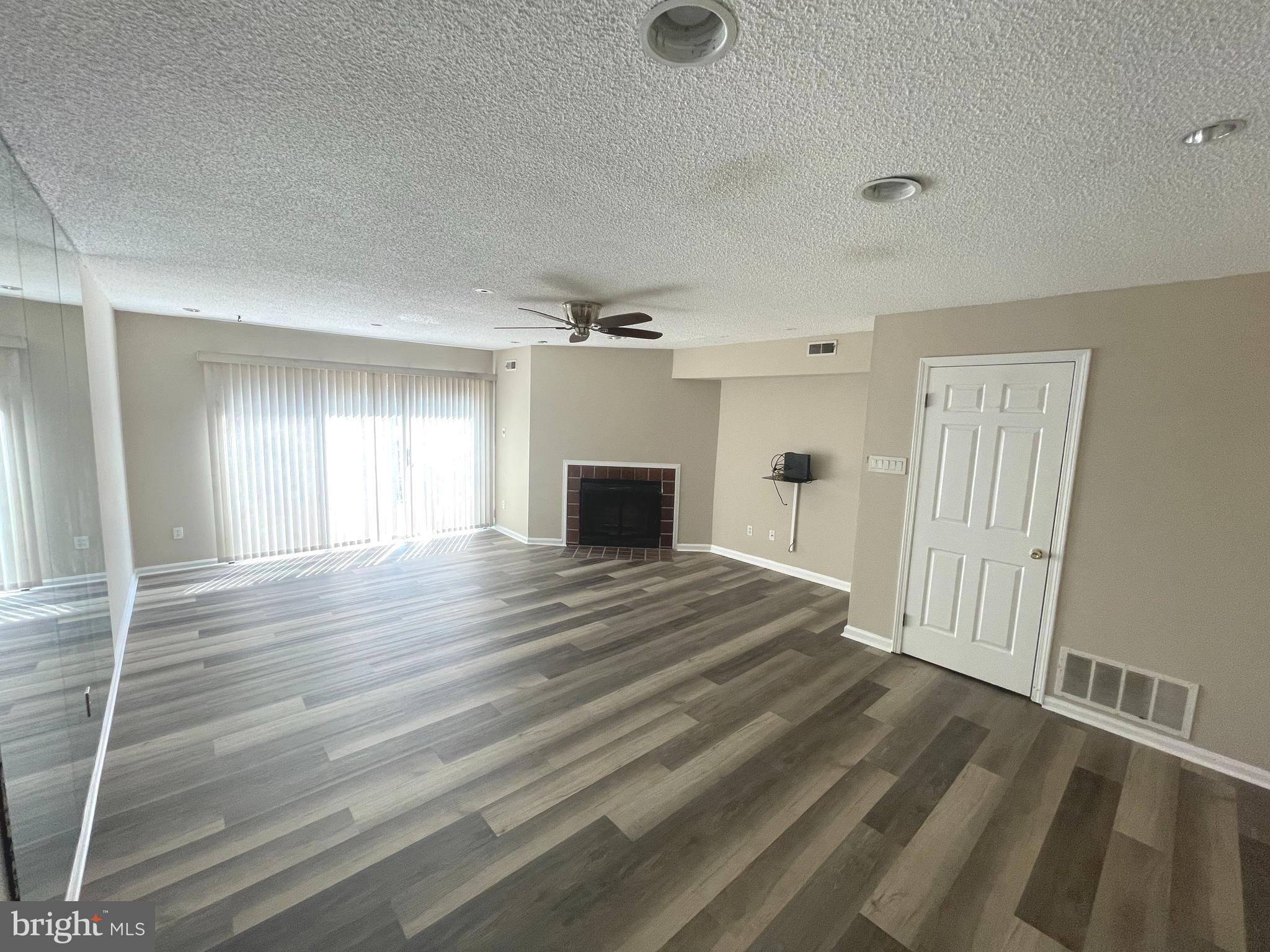 214 Carriage Court, Unit 214 Chesterbrook, PA 19087 - Photo 9 of 41 a view of a livingroom with wooden floor and a ceiling fan