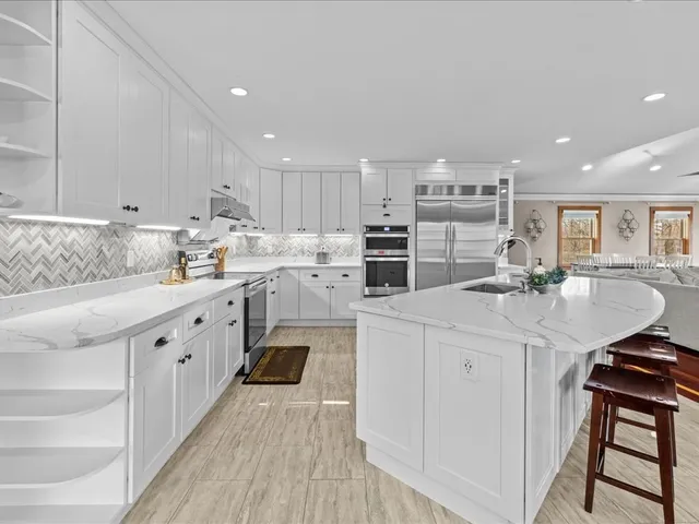 a kitchen with counter top space sink and center island