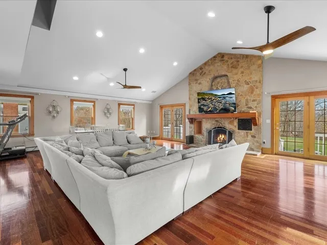 a living room with fireplace furniture and a wooden floor
