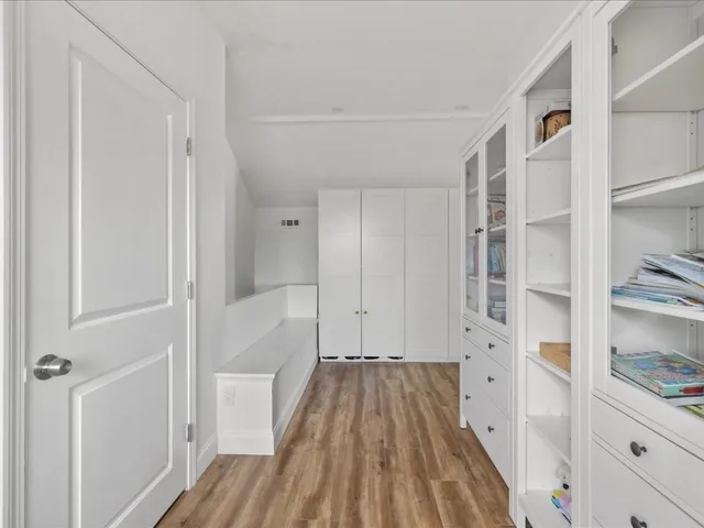 a view of walk in closet with empty racks