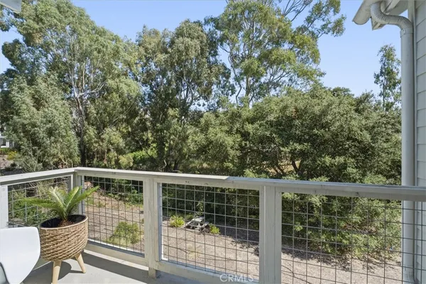 a view of a chair and table in the balcony