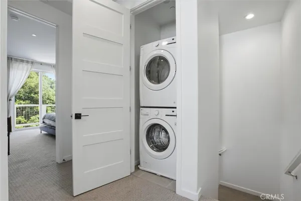 a view of a hallway with washer and dryer