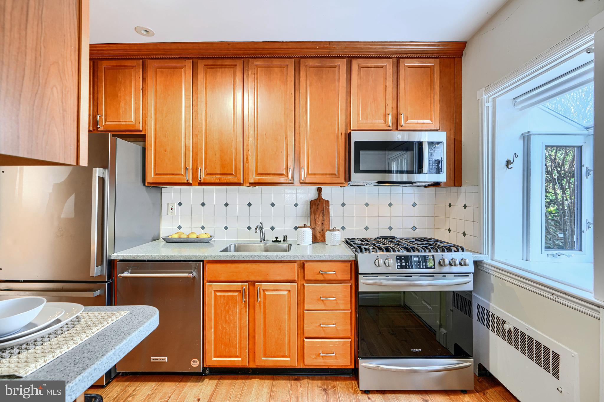 100 Dunkirk Road Baltimore, MD 21212 - Photo 15 of 65 a kitchen with granite countertop a stove top oven microwave and refrigerator