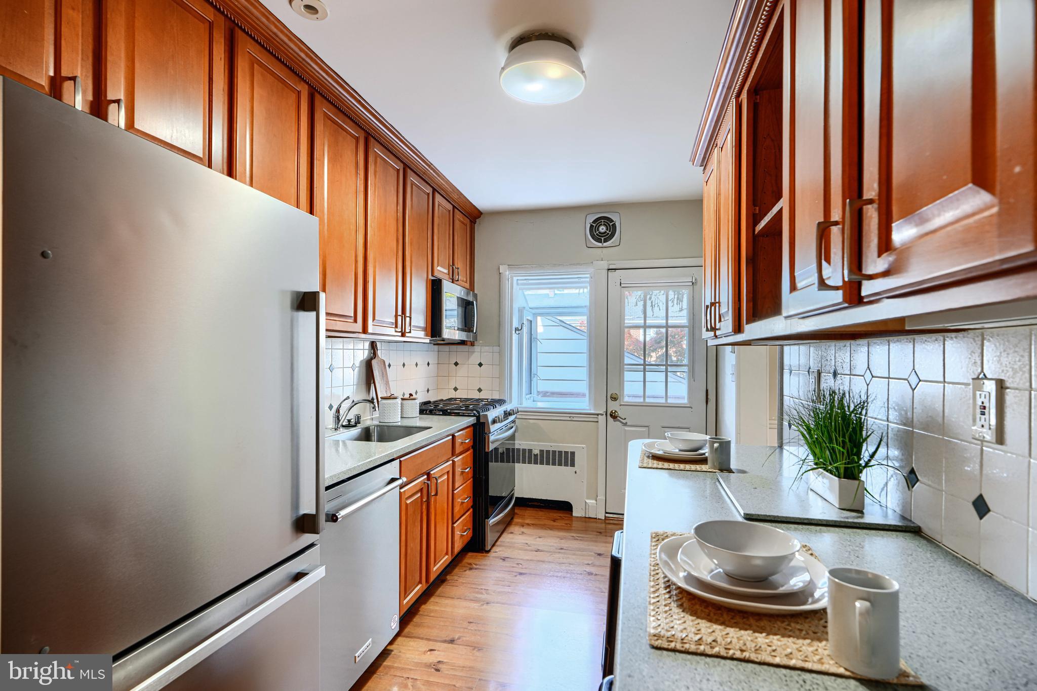 100 Dunkirk Road Baltimore, MD 21212 - Photo 19 of 65 a kitchen with stainless steel appliances granite countertop a stove a sink and a refrigerator