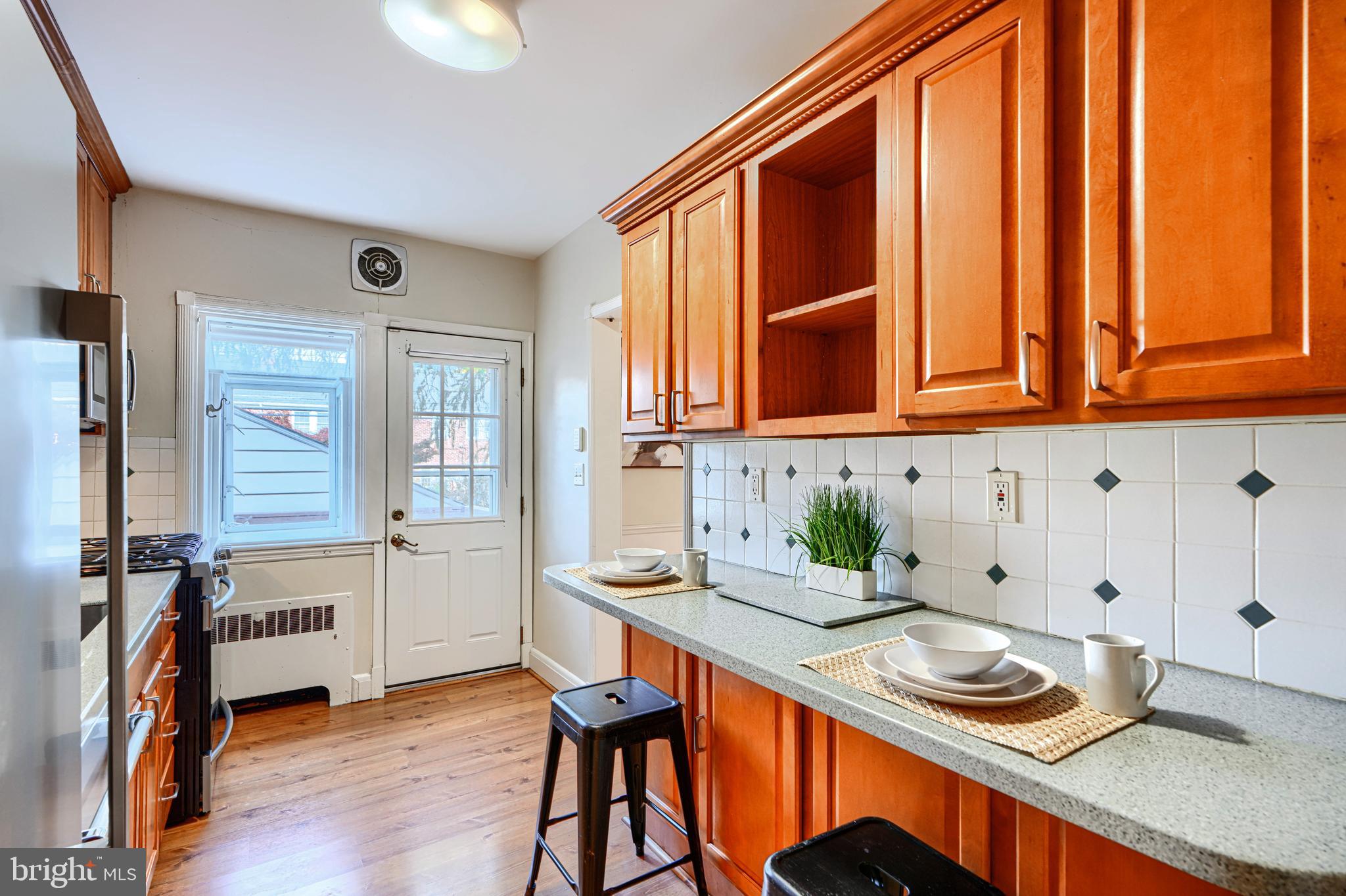 100 Dunkirk Road Baltimore, MD 21212 - Photo 20 of 65 a kitchen with stainless steel appliances granite countertop a sink dishwasher and cabinets with wooden floor