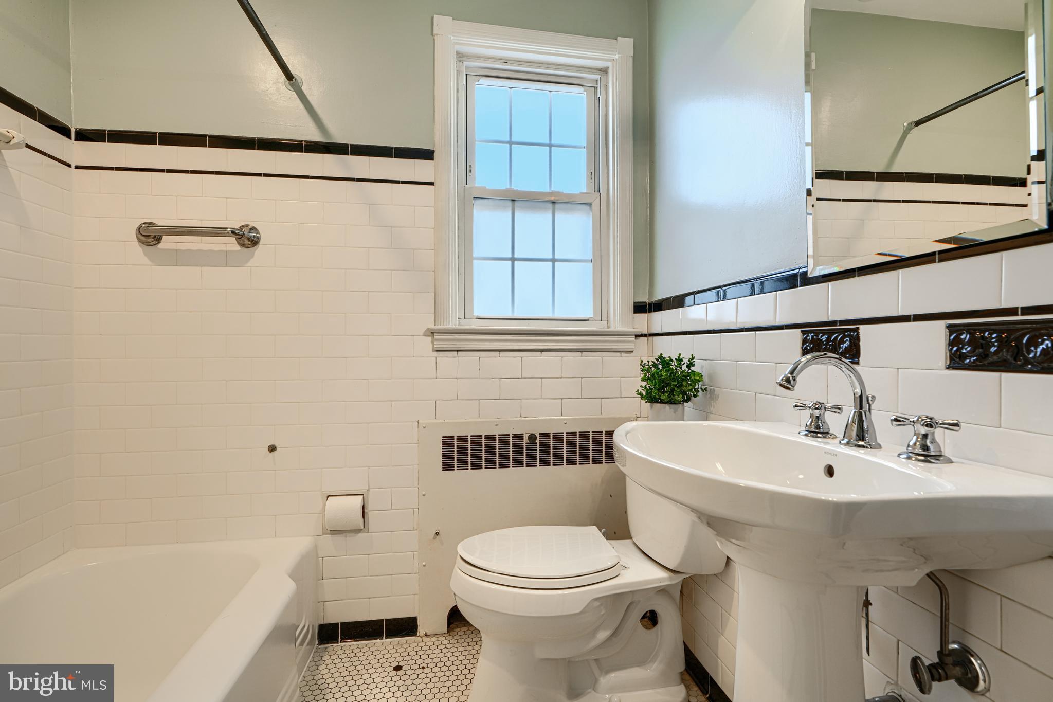 100 Dunkirk Road Baltimore, MD 21212 - Photo 24 of 65 a bathroom with a sink a toilet and a bathtub