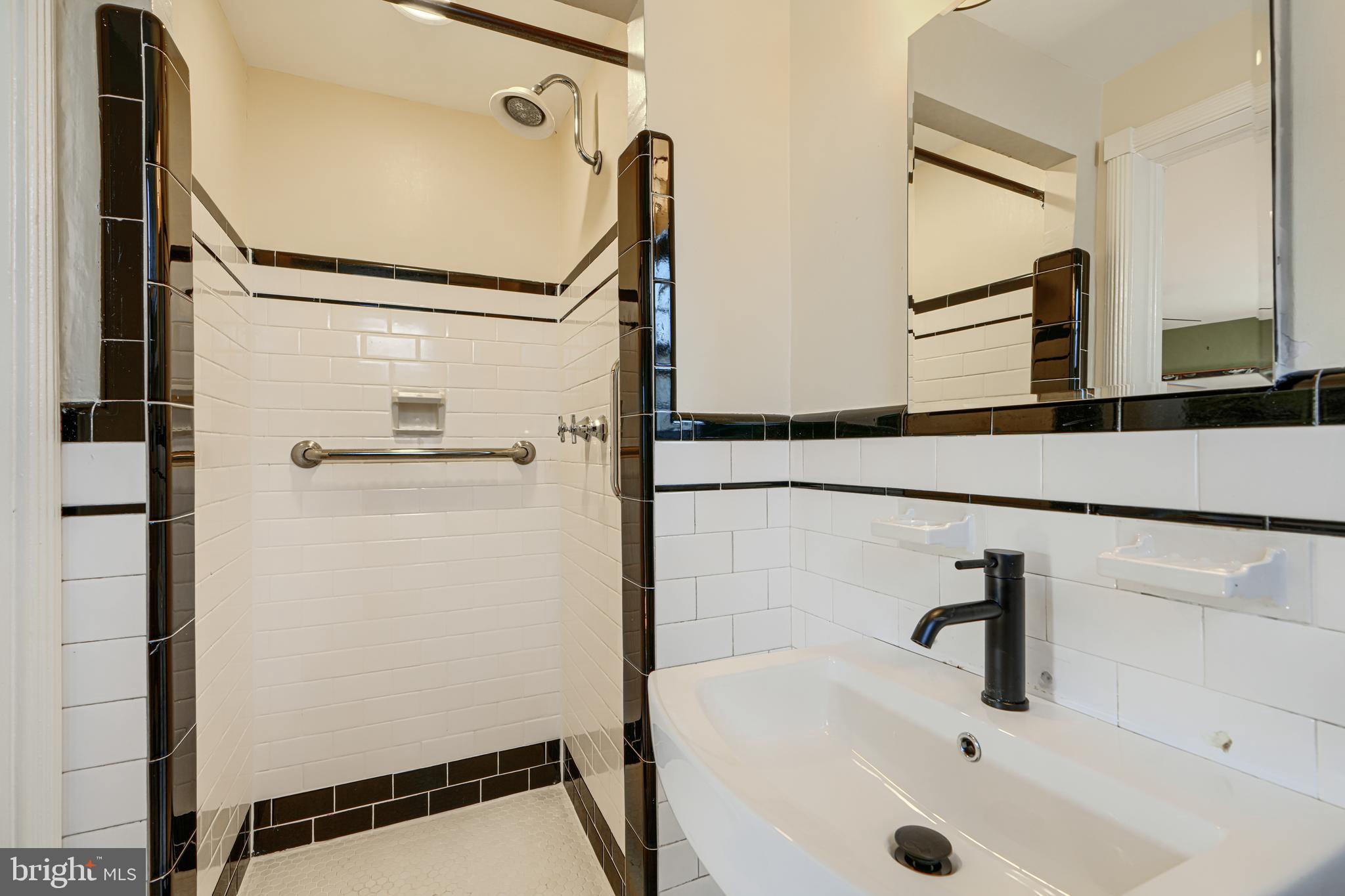 100 Dunkirk Road Baltimore, MD 21212 - Photo 31 of 65 a bathroom with a tub and a sink