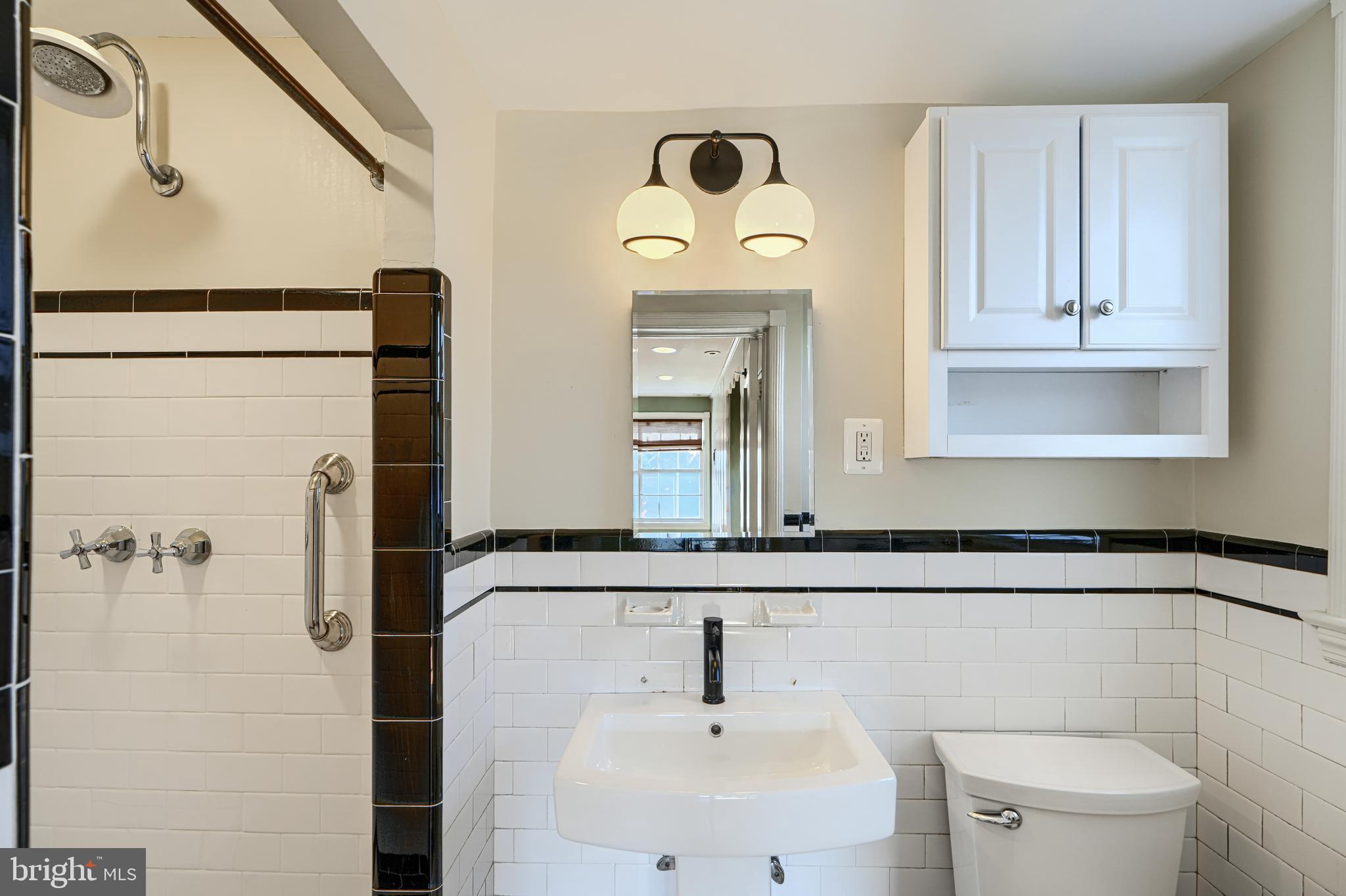 100 Dunkirk Road Baltimore, MD 21212 - Photo 32 of 65 a bathroom with a sink a toilet and a mirror