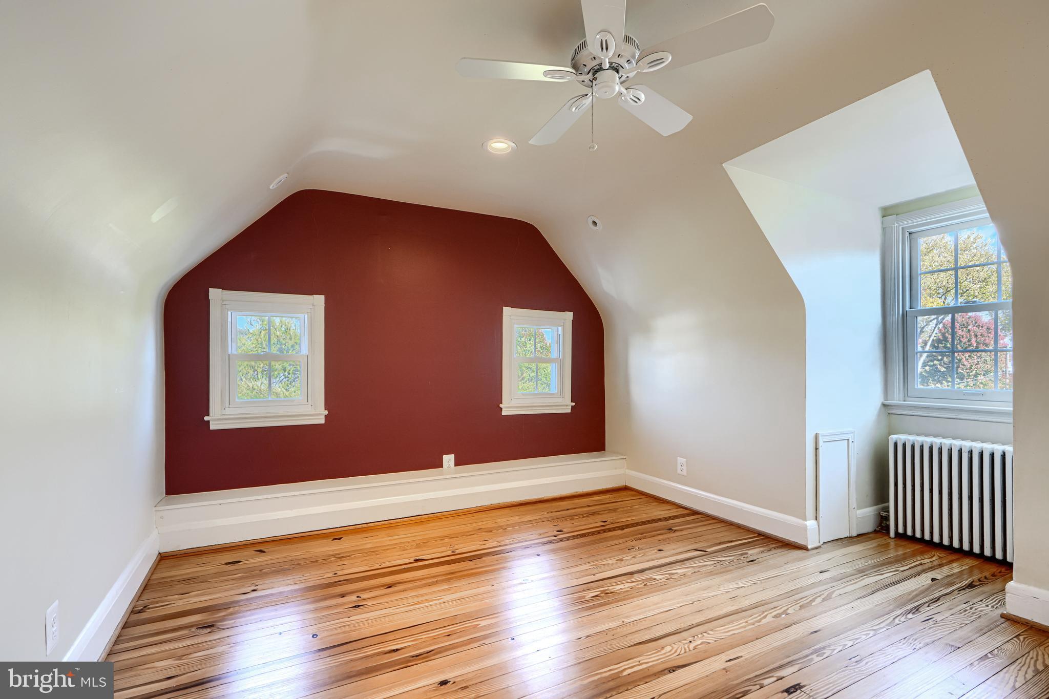 100 Dunkirk Road Baltimore, MD 21212 - Photo 35 of 65 a view of an empty room with wooden floor and a window