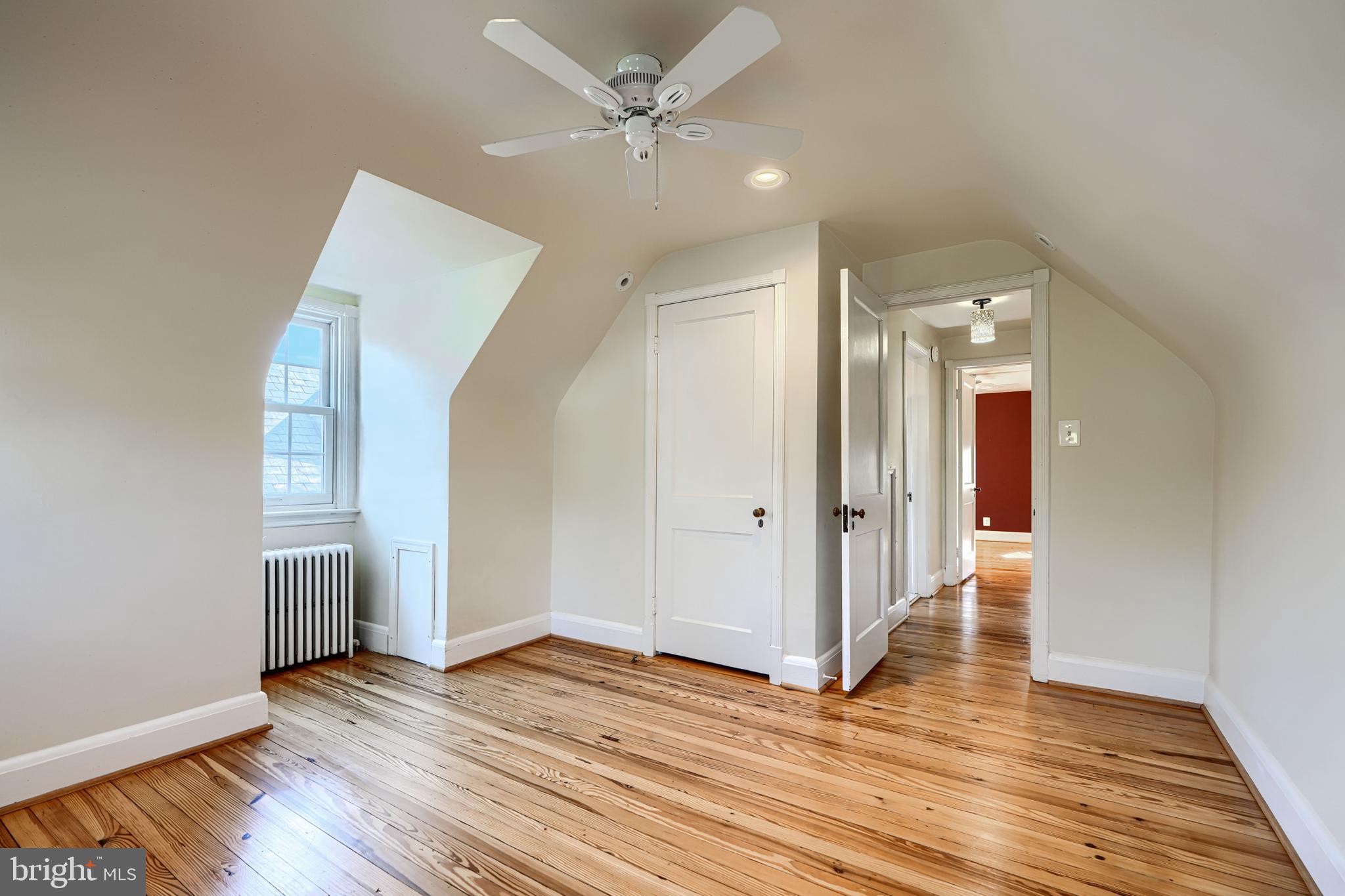 100 Dunkirk Road Baltimore, MD 21212 - Photo 36 of 65 an empty room with wooden floor and ceiling fan