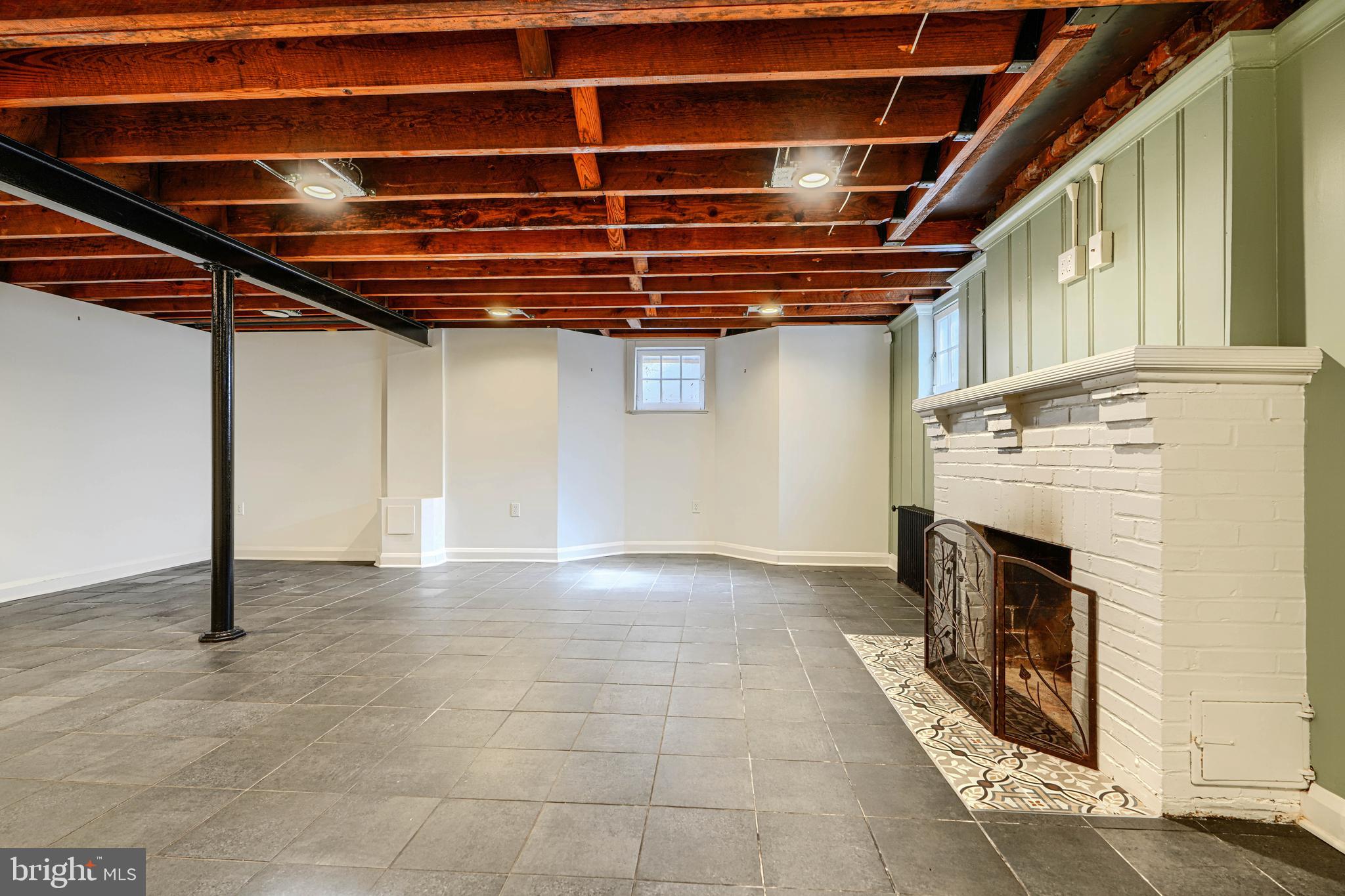 100 Dunkirk Road Baltimore, MD 21212 - Photo 43 of 65 a view of an empty room with wooden floor and a window