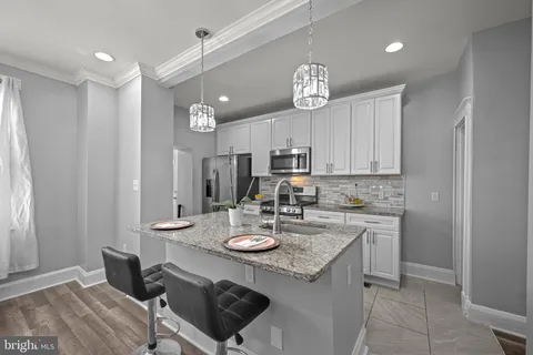 a view of a kitchen and a sink dishwasher with wooden floor