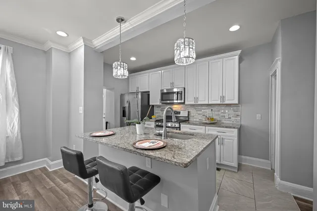 a view of a kitchen and a sink dishwasher with wooden floor