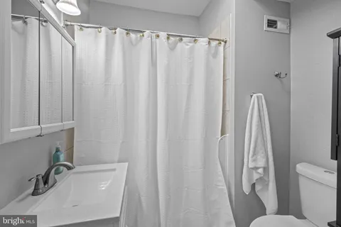 a bathroom with a sink a toilet and a tub