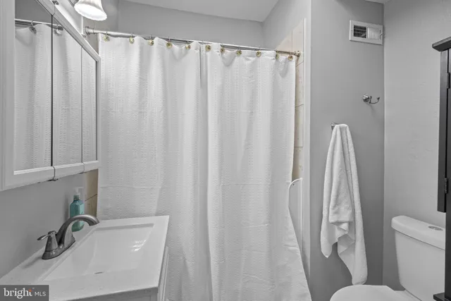 a bathroom with a sink a toilet and a tub