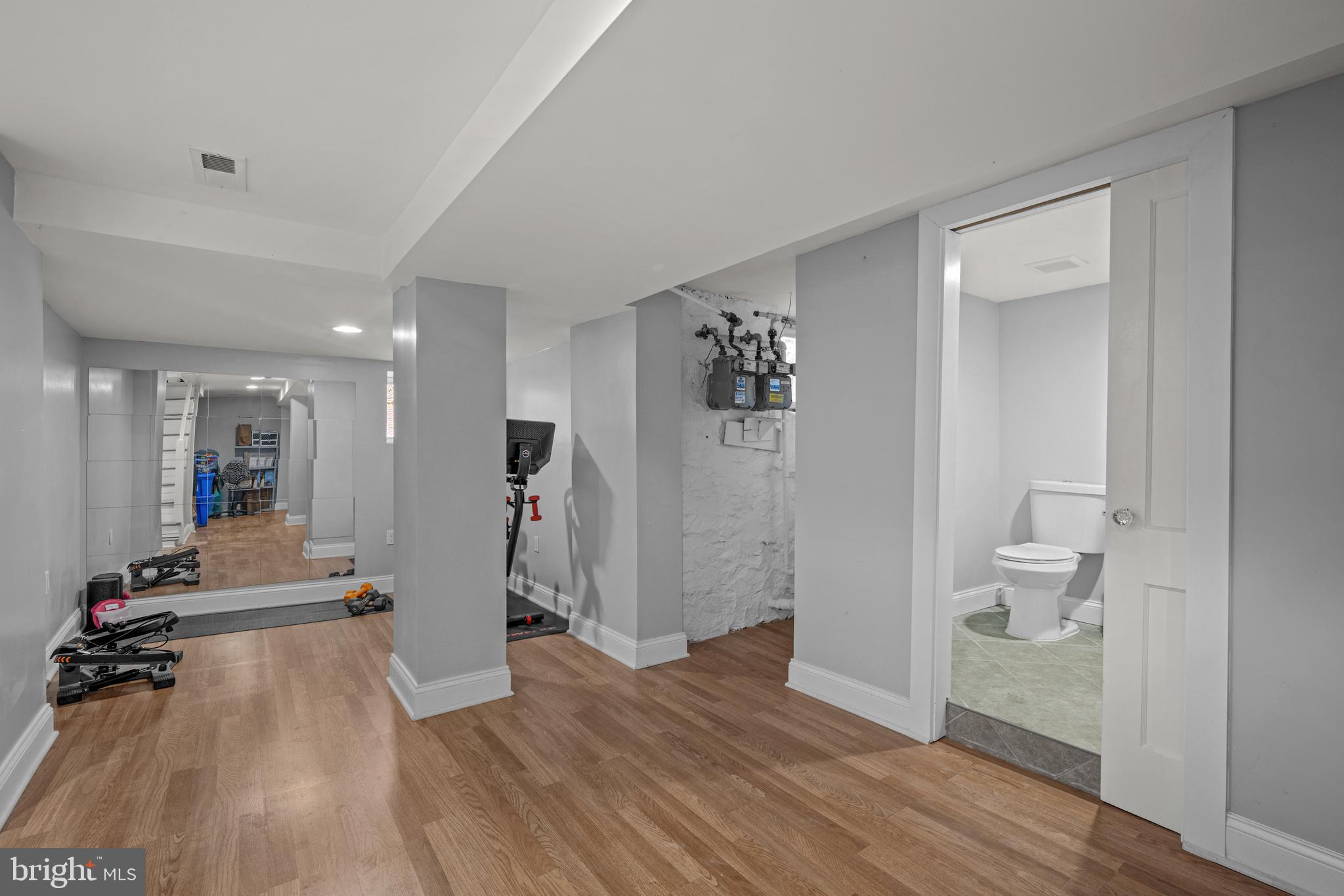 3009 Kentucky Avenue Baltimore, MD 21213 - Photo 27 of 42 a view of a hallway with wooden floor and a bathroom