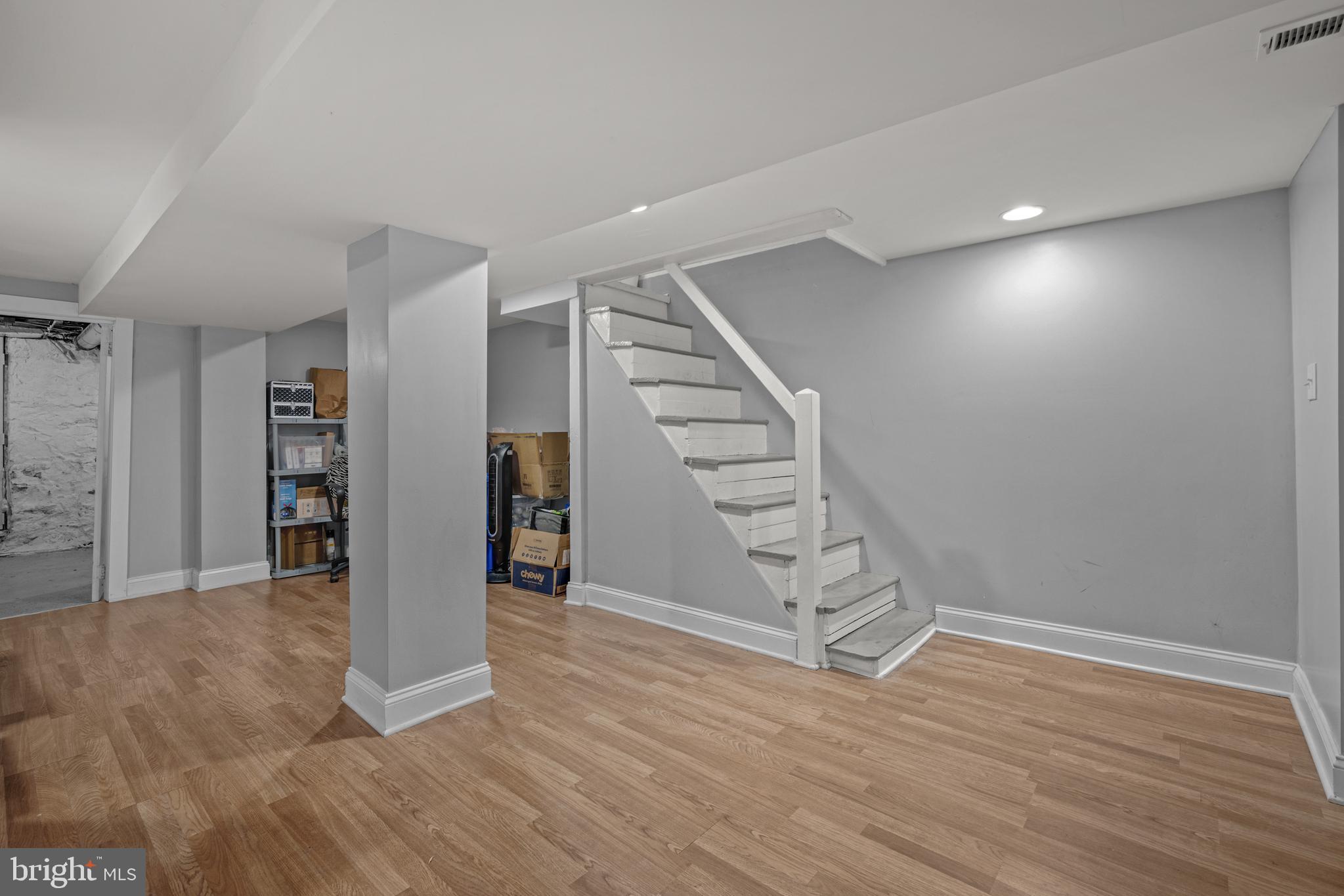 3009 Kentucky Avenue Baltimore, MD 21213 - Photo 29 of 42 a view of an empty room with wooden floor and stairs
