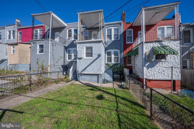 a view of multiple houses with a yard