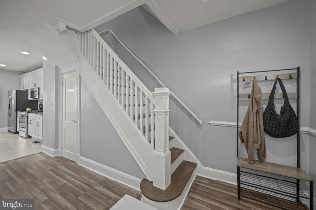 a view of entryway and hall with wooden floor