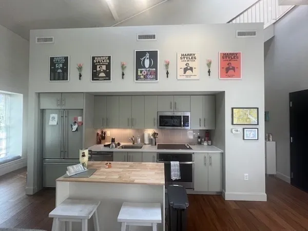 a kitchen with kitchen island stainless steel appliances a stove and a refrigerator