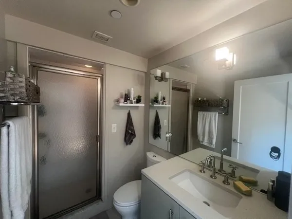 a bathroom with a sink toilet and shower