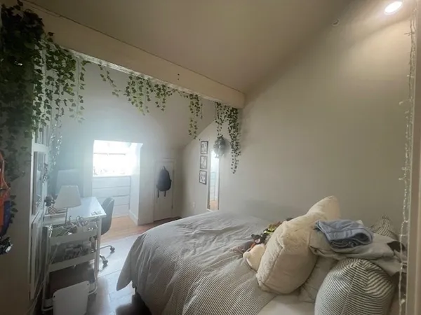 a bedroom with a bed and a mirror