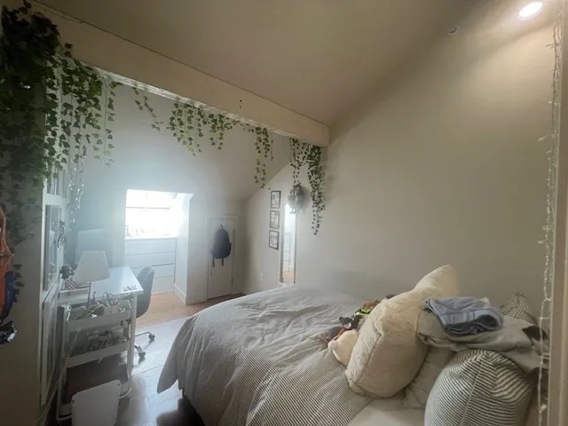 a bedroom with a bed and a mirror