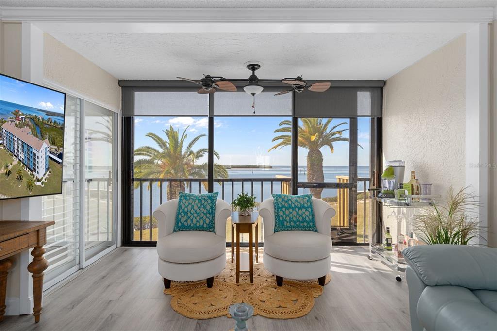 4550 Bay Boulevard, Unit 1211 Port Richey, FL 34668 - Photo 11 of 65 a living room with furniture and a floor to ceiling window