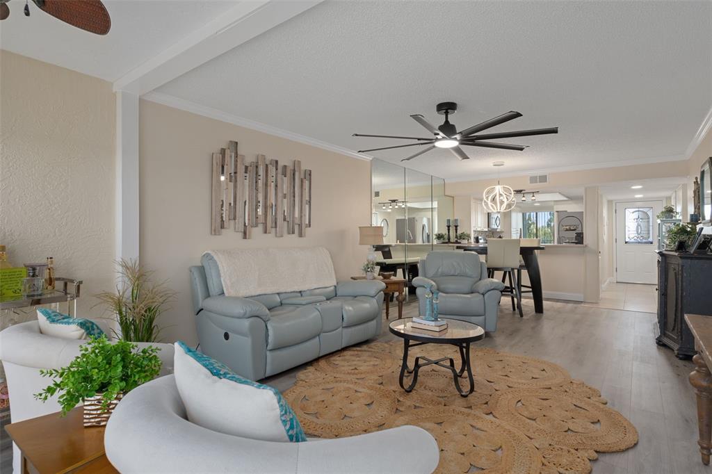 4550 Bay Boulevard, Unit 1211 Port Richey, FL 34668 - Photo 12 of 65 a living room with furniture and a chandelier