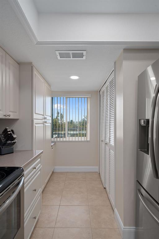 4550 Bay Boulevard, Unit 1211 Port Richey, FL 34668 - Photo 20 of 65 a kitchen with stainless steel appliances a refrigerator sink and stove