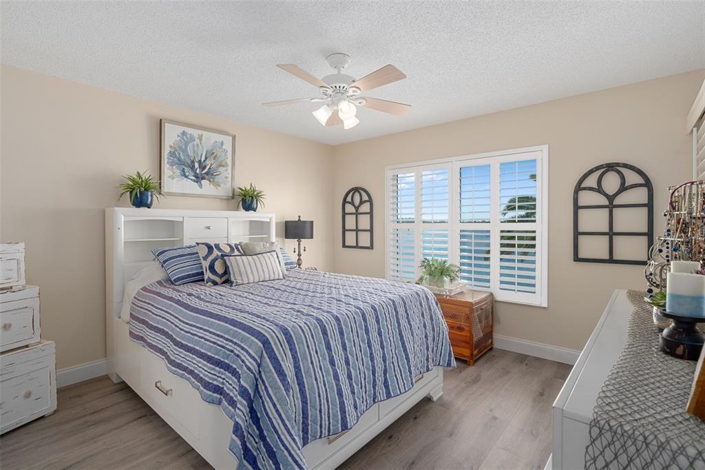 4550 Bay Boulevard, Unit 1211 Port Richey, FL 34668 - Photo 22 of 65 a bedroom with a large bed and a chandelier