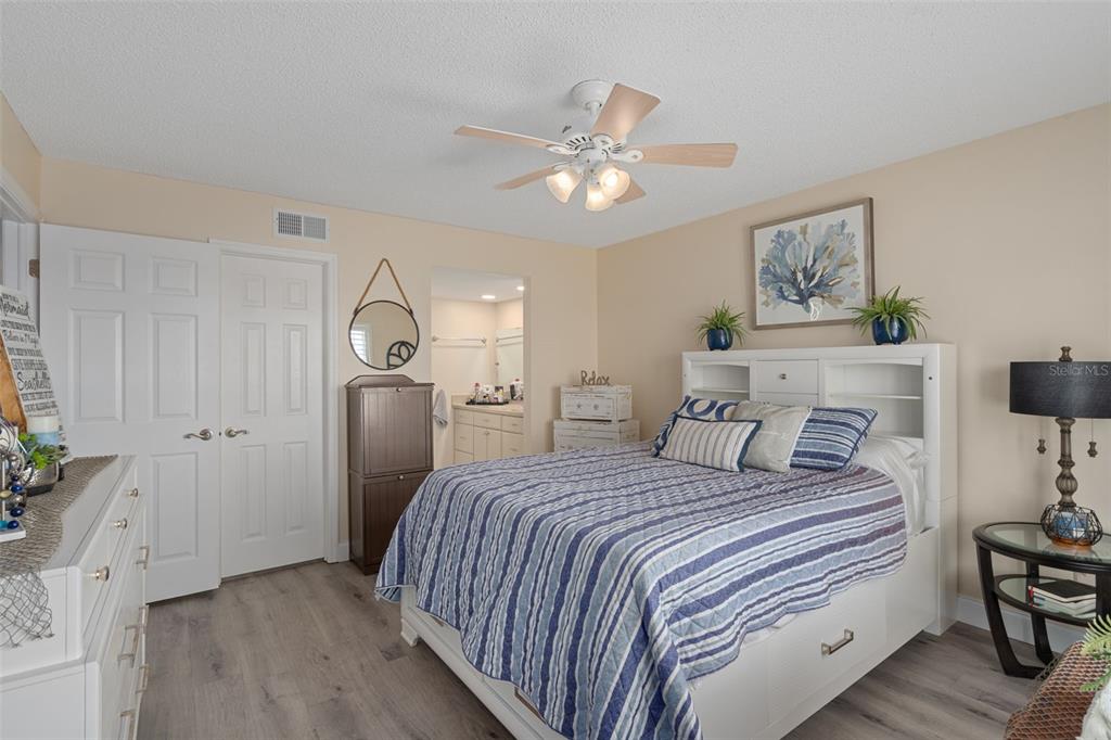 4550 Bay Boulevard, Unit 1211 Port Richey, FL 34668 - Photo 23 of 65 a bedroom with a bed and a chandelier