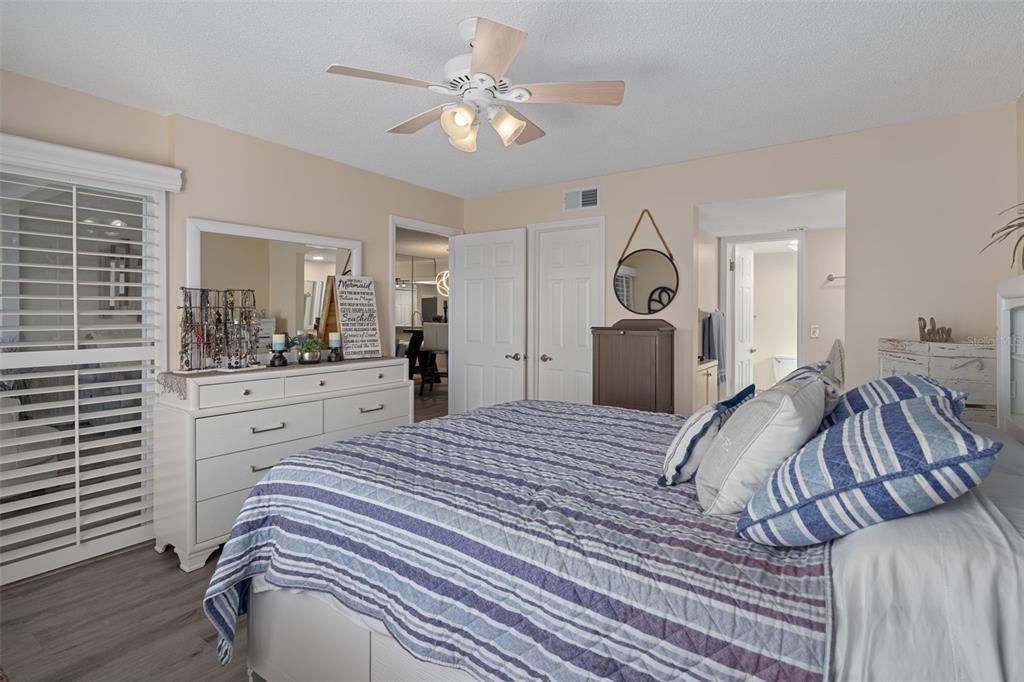 4550 Bay Boulevard, Unit 1211 Port Richey, FL 34668 - Photo 24 of 65 a bedroom with a bed and a chandelier