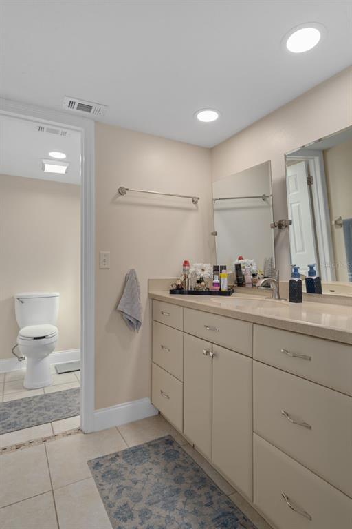 4550 Bay Boulevard, Unit 1211 Port Richey, FL 34668 - Photo 26 of 65 a spacious bathroom with a sink and a mirror