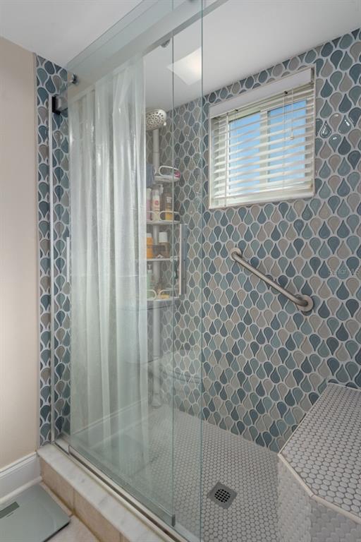 4550 Bay Boulevard, Unit 1211 Port Richey, FL 34668 - Photo 28 of 65 a bathroom with a shower and a sink