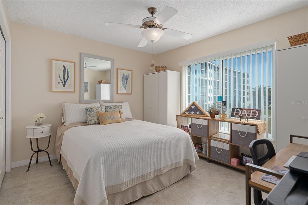 4550 Bay Boulevard, Unit 1211 Port Richey, FL 34668 - Photo 32 of 65 a bedroom with a bed and a chandelier