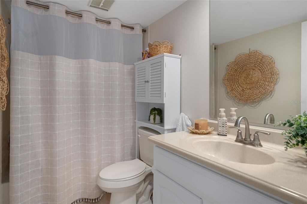 4550 Bay Boulevard, Unit 1211 Port Richey, FL 34668 - Photo 33 of 65 a bathroom with a granite countertop sink and a mirror