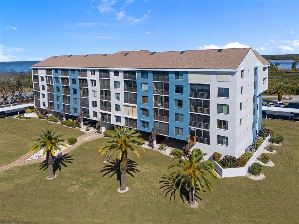 4550 Bay Boulevard, Unit 1211 Port Richey, FL 34668 - Photo 39 of 65 a view of a chairs with table in front of a house