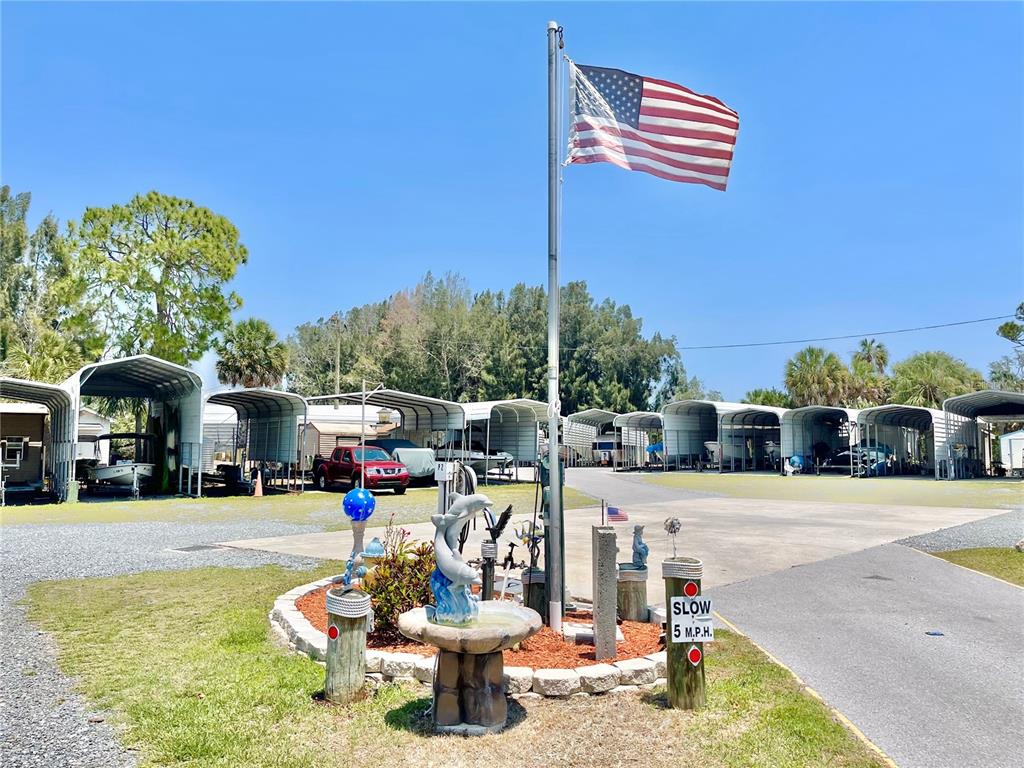 4550 Bay Boulevard, Unit 1211 Port Richey, FL 34668 - Photo 55 of 65 a view of a patio with a table and chairs under an umbrella