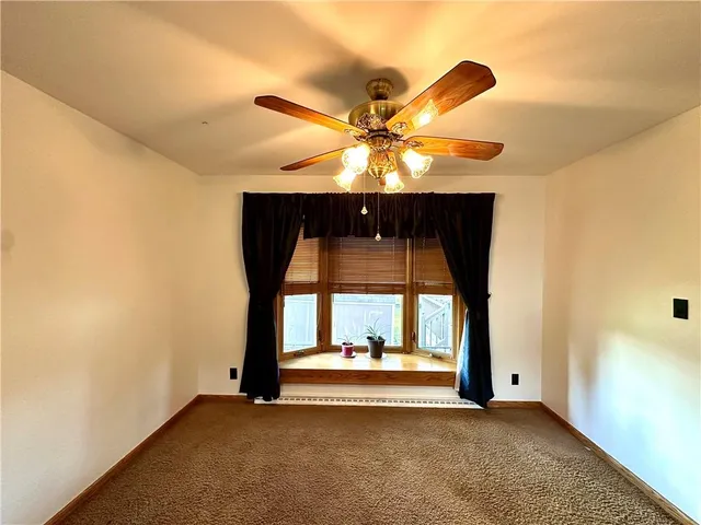 a view of an empty room with a fireplace