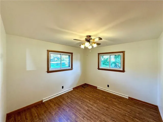 a view of a room with wooden floor and window