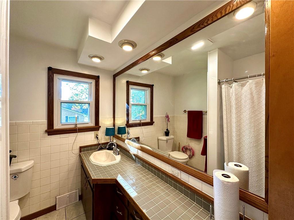 3025 Spring Garden Avenue New Castle, PA 16105 - Photo 25 of 37 a bathroom with a sink double vanity and a mirror