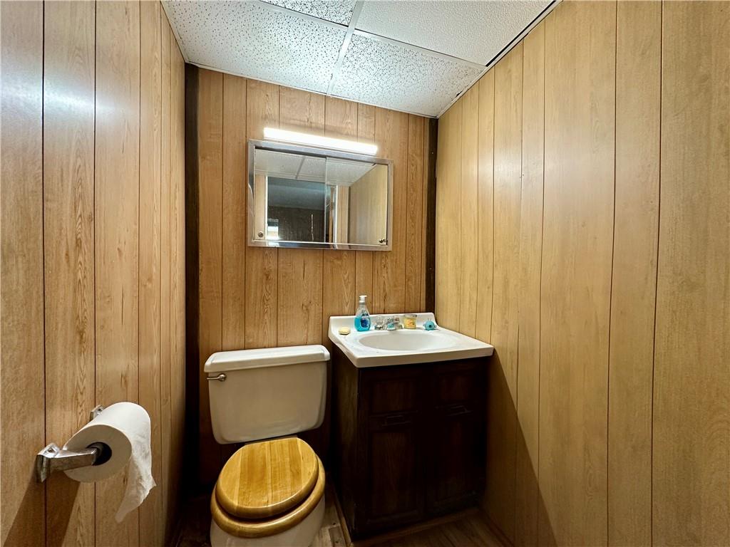 3025 Spring Garden Avenue New Castle, PA 16105 - Photo 31 of 37 a bathroom with a toilet a sink and mirror
