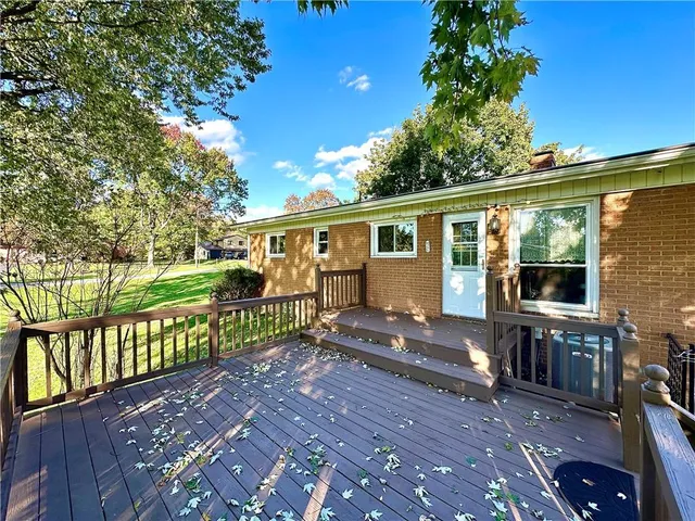 a view of house with backyard outdoor seating and hardwood