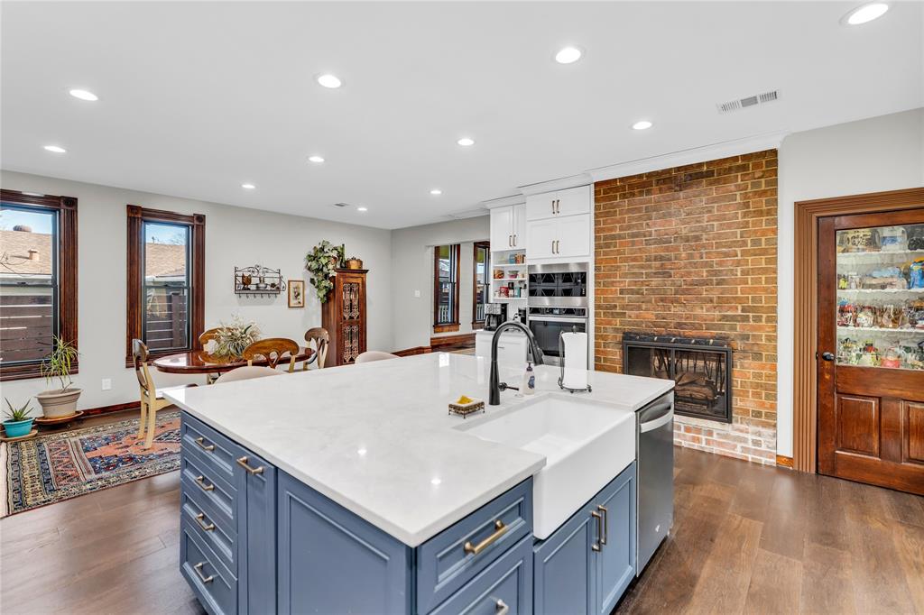 304 North Church Street Pilot Point, TX 76258 - Photo 17 of 40 a large kitchen with sink a counter top space and stainless steel appliances