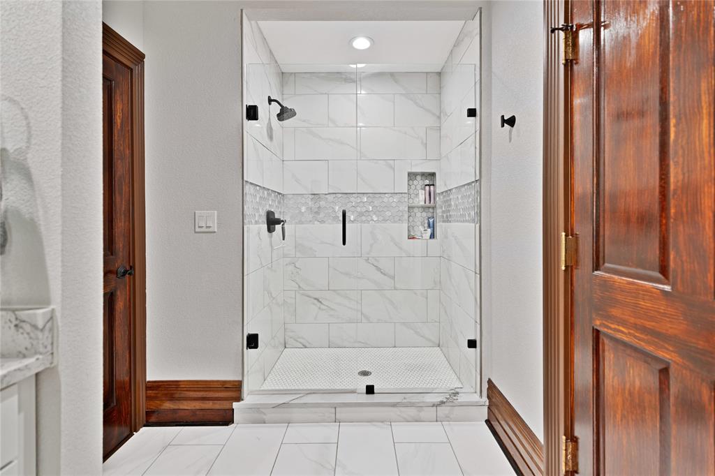 304 North Church Street Pilot Point, TX 76258 - Photo 22 of 40 a bathroom with a bathtub and a shower
