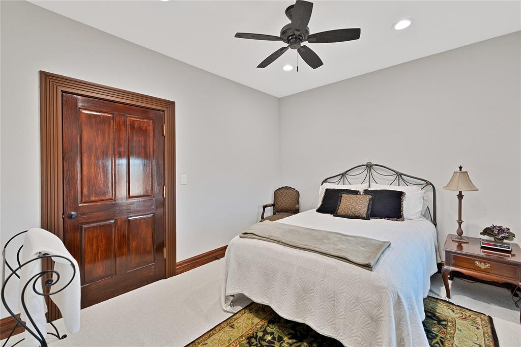 304 North Church Street Pilot Point, TX 76258 - Photo 23 of 40 a bedroom with a bed and a chandelier